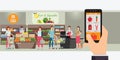 Hand holding smartphone with shopping app, Interior store inside, Grocery delivery internet order, Online supermarket concept