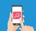 Hand holding smartphone and touching the screen with search button. Magnifying glass icon. Royalty Free Stock Photo