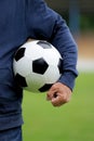 Hand holding soccer ball on stadium Royalty Free Stock Photo