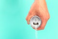 Hand holding soda can pouring a crazy amount of sugar in metaphor of sugar content of a refresh drink isolated on blue background Royalty Free Stock Photo