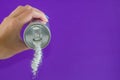 Hand holding soda can pouring a crazy amount of sugar in metaphor of sugar content of a refresh drink isolated on purple Royalty Free Stock Photo