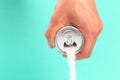 Hand holding soda can pouring a crazy amount of sugar in metaphor of sugar content of a refresh drink isolated on blue background Royalty Free Stock Photo