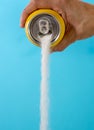 Hand holding a soda can pouring sugar Royalty Free Stock Photo