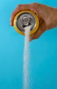 Hand holding a soda can pouring sugar Royalty Free Stock Photo