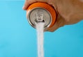 Hand holding a soda can pouring sugar Royalty Free Stock Photo