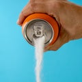 Hand holding a soda can pouring sugar Royalty Free Stock Photo