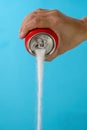 Hand holding a soda can pouring sugar Royalty Free Stock Photo