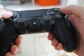 Hand holding Sony DualShock 4 controller for PlayStation 4 PS4, Home video game console devel Royalty Free Stock Photo