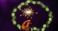Hand holding sparkler in green circle Royalty Free Stock Photo