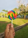 Hand holding a spiral sweet lolipop candy