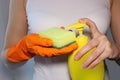 Hand holding a sponge, pouring detergent. The concept of service for cleaning apartments and premises, cleanliness. Housewife maid