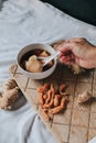 Hand holding spoon eating homemade soy custard in hot ginger syrup eat with with deep fried powder pastry good for health