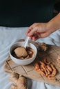 Hand holding spoon eating homemade soy custard in hot ginger syrup eat with with deep fried powder pastry good for health