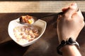 Hand holding spoon full of cornflakes and milk with sunlight Royalty Free Stock Photo