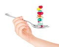 Hand holding a spoon with pills Royalty Free Stock Photo