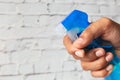 Hand holding spray bottle for cleaning surface for coronavirus Royalty Free Stock Photo