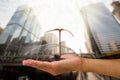 Hand holding sprout on blurred city background Royalty Free Stock Photo