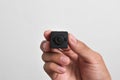 Hand holding a spy camera, Black security camera Royalty Free Stock Photo