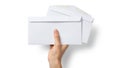 A hand holding a stack of blank white envelopes against a plain background Royalty Free Stock Photo