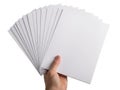 A hand holding a stack of blank white envelopes ready for mailing. isolated on white background Royalty Free Stock Photo