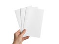 Hand holding a stack of blank white paper sheets isolated on white background Royalty Free Stock Photo