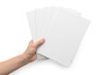 A hand holding a stack of blank white paper sheets against a white background Royalty Free Stock Photo