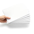 Hand holding a stack of blank white paper sheets with dotted lines Royalty Free Stock Photo