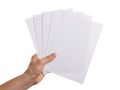 A hand holding a stack of blank white paper sheets with dotted lines Royalty Free Stock Photo
