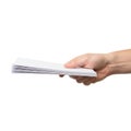 A hand holding a stack of blank white paper sheets ready for use Royalty Free Stock Photo