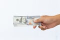 Hand Holding Stack of U.S. Hundred Dollar Bills Across White Background. Royalty Free Stock Photo