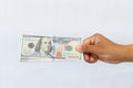 Hand Holding Stack of U.S. Hundred Dollar Bills Across White Background. Royalty Free Stock Photo