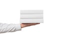 Hand holding stack of white rectangular objects Royalty Free Stock Photo