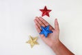 Hand holding a star with different colors Royalty Free Stock Photo