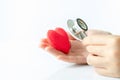 Hand holding stethoscope use to hear sounds within the red heart Royalty Free Stock Photo