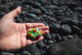 A hand holding a stone with many colors Royalty Free Stock Photo