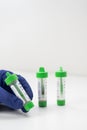 Hand holding stool sample collection kit for parasite testing Royalty Free Stock Photo