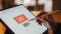 Stylus interacts with a tablet screen displaying a 20 off disc Royalty Free Stock Photo