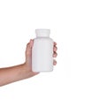 Hand holding supplements or vitamin bottle