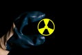 A hand holding a symbol for radioactivity.