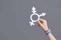 Hand holding a symbol of the transgender community with a trans flag bracelet