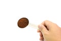 Hand holding table spoon with ground coffee Royalty Free Stock Photo