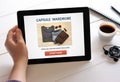 Hand holding tablet with capsule wardrobe concept on screen Royalty Free Stock Photo
