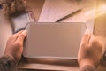 Hand of holding tablet on desk