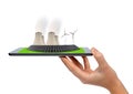 Hand holding tablet with a wind turbines, solar panel and nuclear power plant Royalty Free Stock Photo