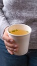 Hand holding a takeaway cup with Chicken broth soup Royalty Free Stock Photo