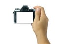 Hand holding and taking shot blank display mirrorless camera isolated Royalty Free Stock Photo