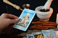 Hand holding tarot card, fortune telling, canvas napkin background Royalty Free Stock Photo