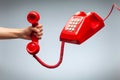 Hand holding telephone, classic red telephone receiver Royalty Free Stock Photo