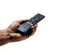 Hand holding television and audio remote control on white background Royalty Free Stock Photo