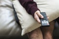 Hand holding television remote control